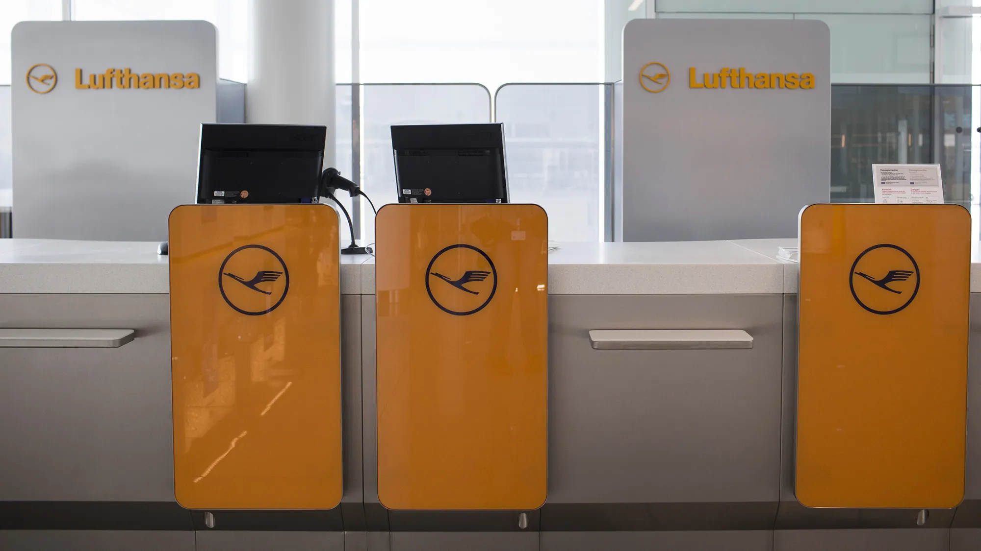 Passenger check in desks operated by Deutsche Lufthansa AG sit ahead of use at Munich Airport's Terminal 2 during the official opening ceremony in Munich, Germany, on Friday, April 22, 2016. 'The expansion of Terminal 2 with the new satellite building will make the Lufthansa Group airlines operating in Munich a better and more attractive option for passengers from all over the world,' Carsten Spohr, chief executive officer of Deutsche Lufthansa AG said.
