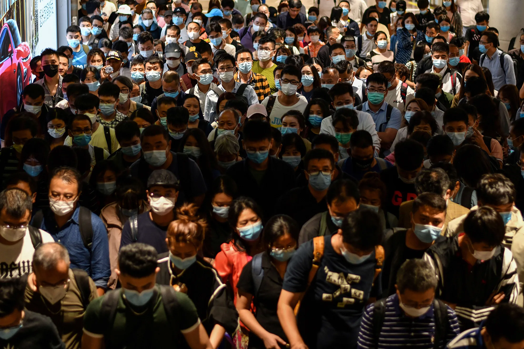 Passengers wearing protective masks arrive at Pudong International Airport in Shanghai on Sept. 29.