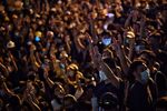 Pro-democracy protesters hold up the three-finger salute during an anti-government rally in Bangkok on Oct. 26.