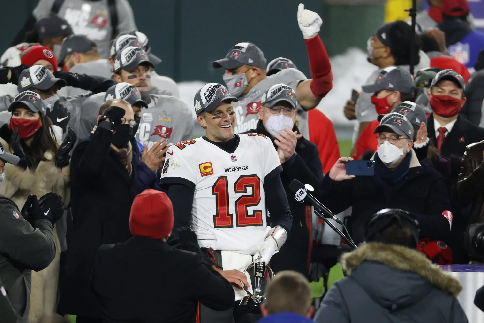 Tom Brady celebrates with teammates after their 31 to 26 win over the Green Bay Packers on Jan. 24.