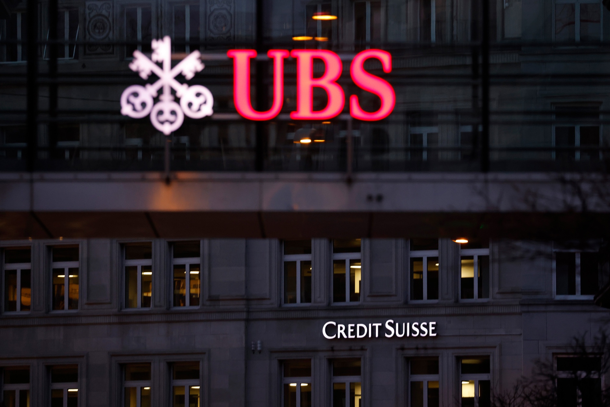 A Credit Suisse bank branch beyond a UBS Group office building walkway in Zurich, Switzerland in 2023.