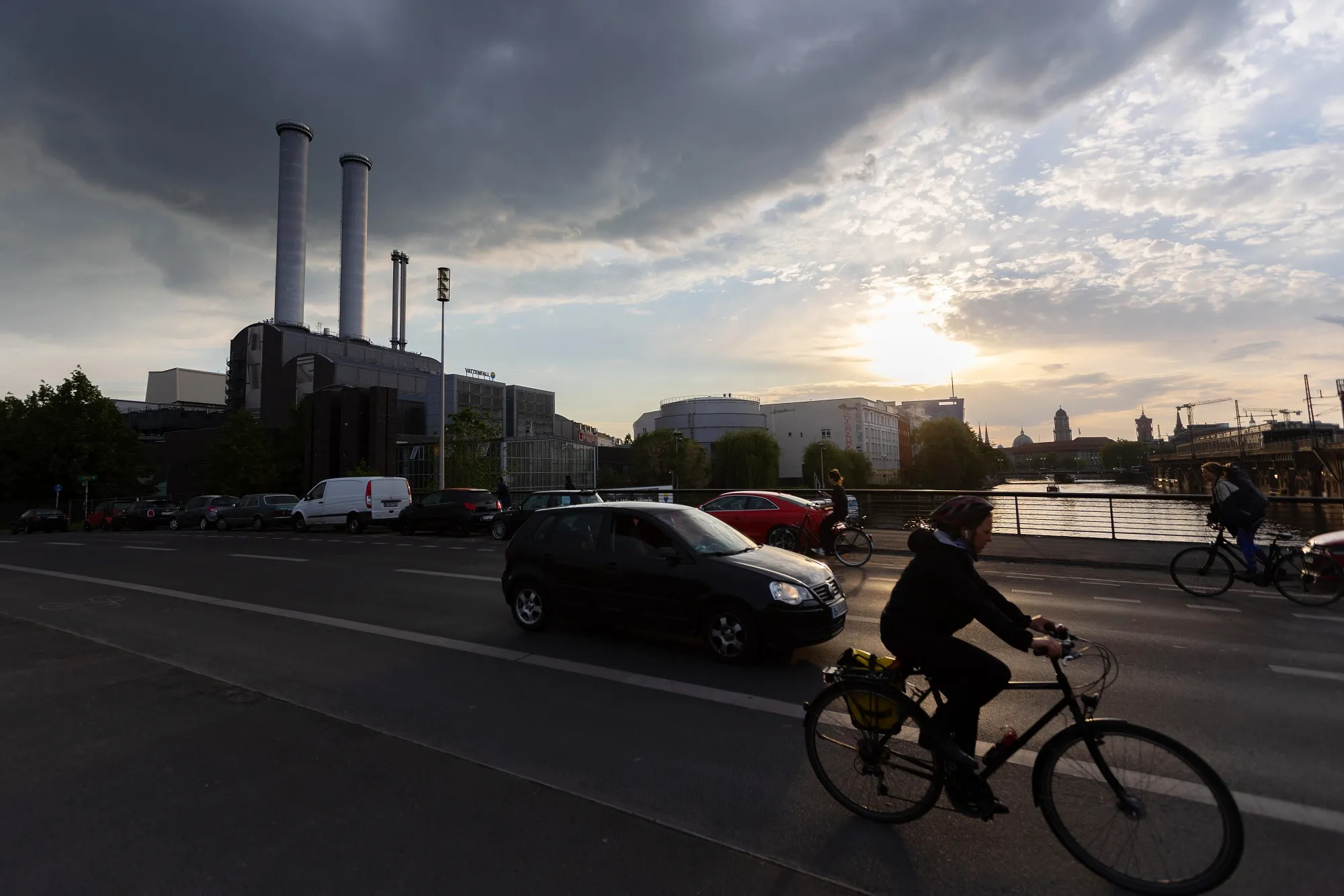 Cyclists and motorists cross a bridge over the Spree river near the Mitte Combined Heat and Power natural gas power plant in Berlin, Germany.&nbsp;