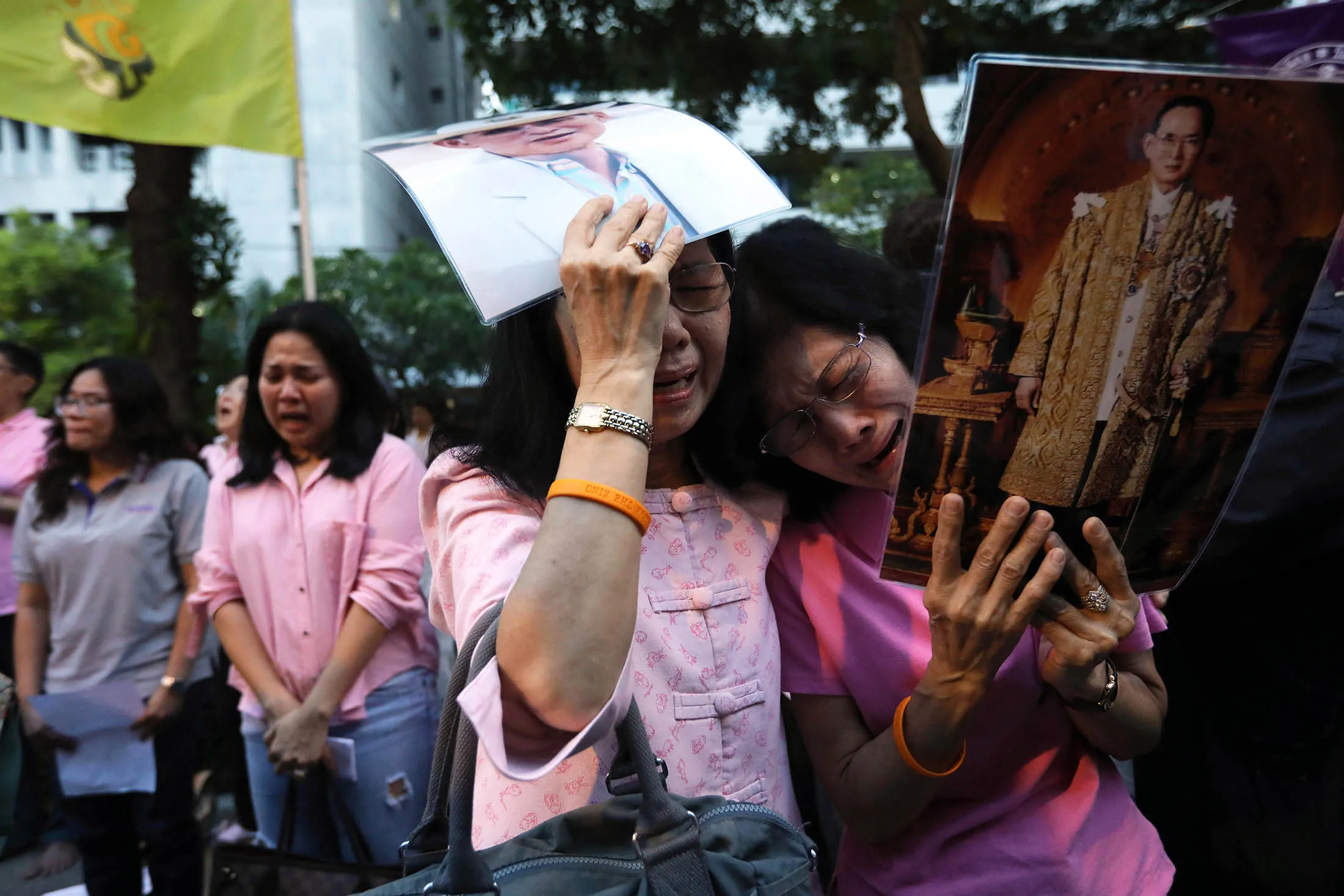 People mourn outside Siriraj Hospital following the announcement of the death of Thai King Bhumibol Adulyadej on Oct. 13.
