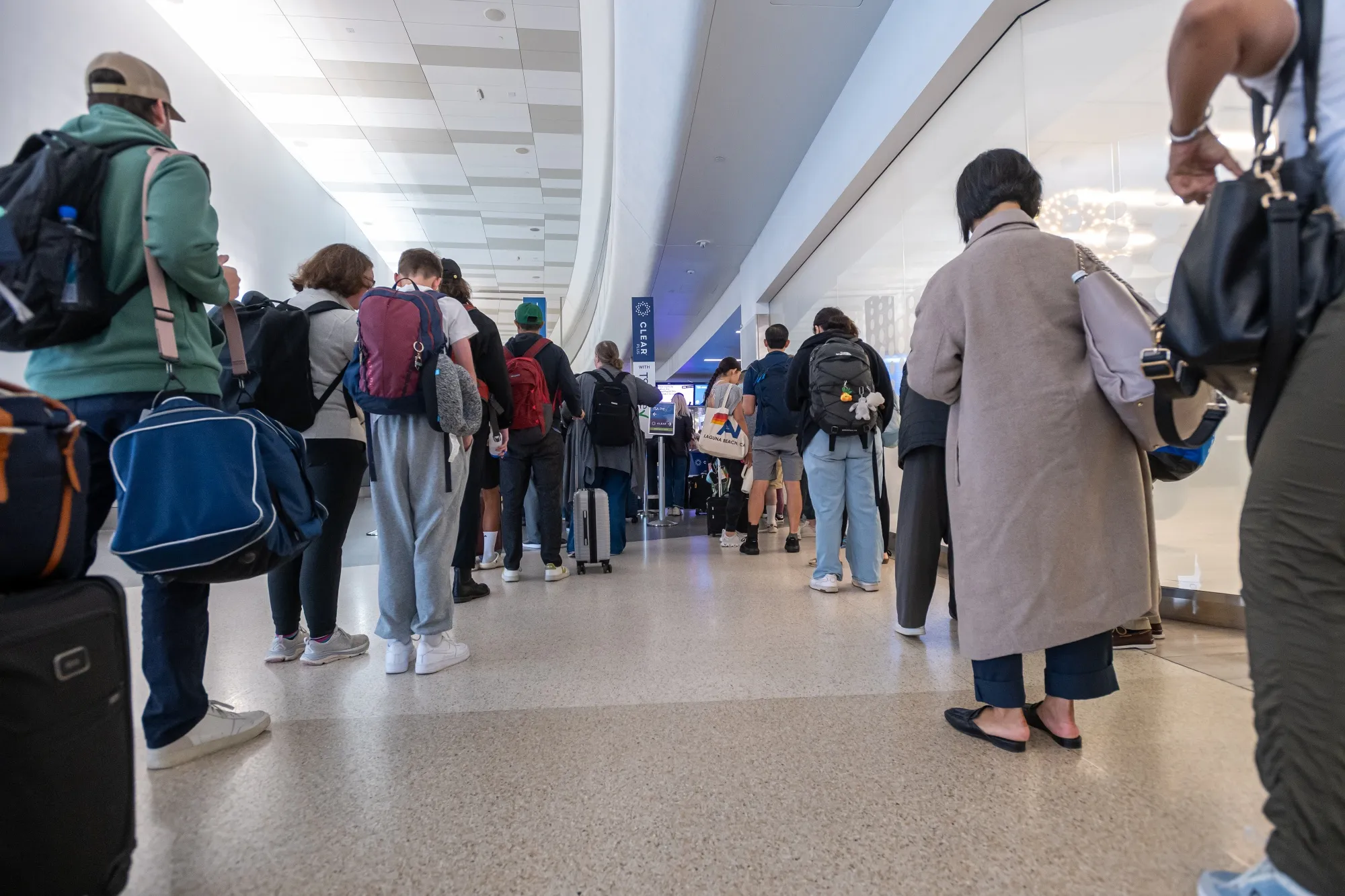 Travelers wait to go through security at San Francisco International Airport.