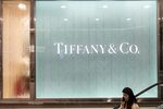A shopper rides an escalator outside a Tiffany & Co. store in Shanghai, China, on Thursday, Dec. 19, 2019.