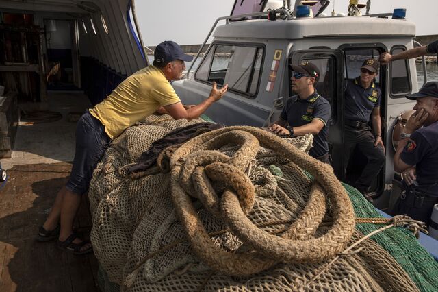 The agents stop to talk to a fisherman at the port of Durres, where the Guardia di Finanza has an office and works closely with Albanian authorities to catch fuel smugglers.