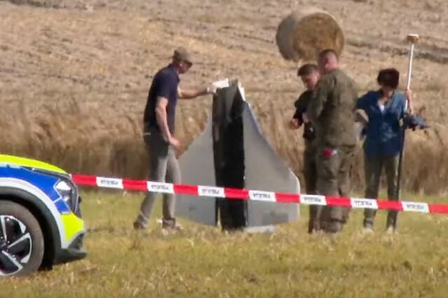 In this still from a video, police and military police officers secure parts of an object shot down by Polish authorities in Wohyn on Sept. 10. 