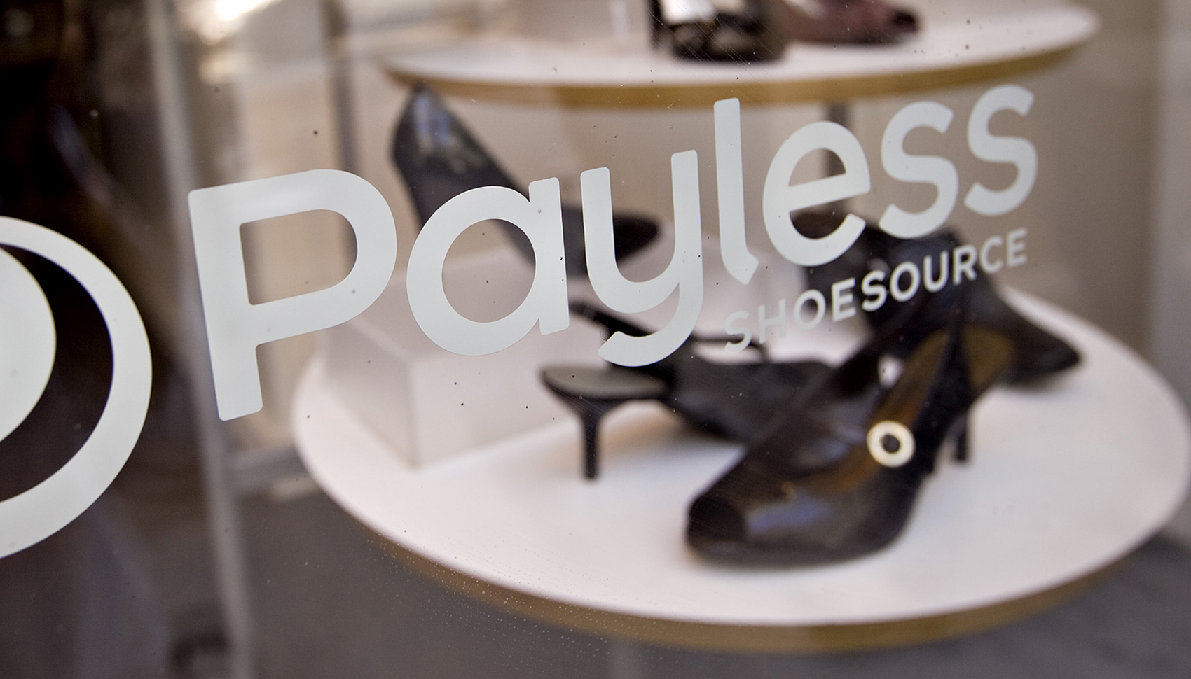 Shoes sit on display in the window of a Payless ShoeSource store in New York.
