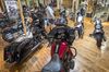 Customers view a Harley-Davidson Inc. motorcycle at the company's dealership in South San Francisco, California, U.S., on Tuesday, June 26, 2018. President Donald Trump appeared to turn on an iconic American company he once embraced, accusing Harley-Davidson of using new tariffs on trade as cover to shift some production abroad as he threatened the motorcycle manufacturer with a "big tax" on bikes imported to the U.S.