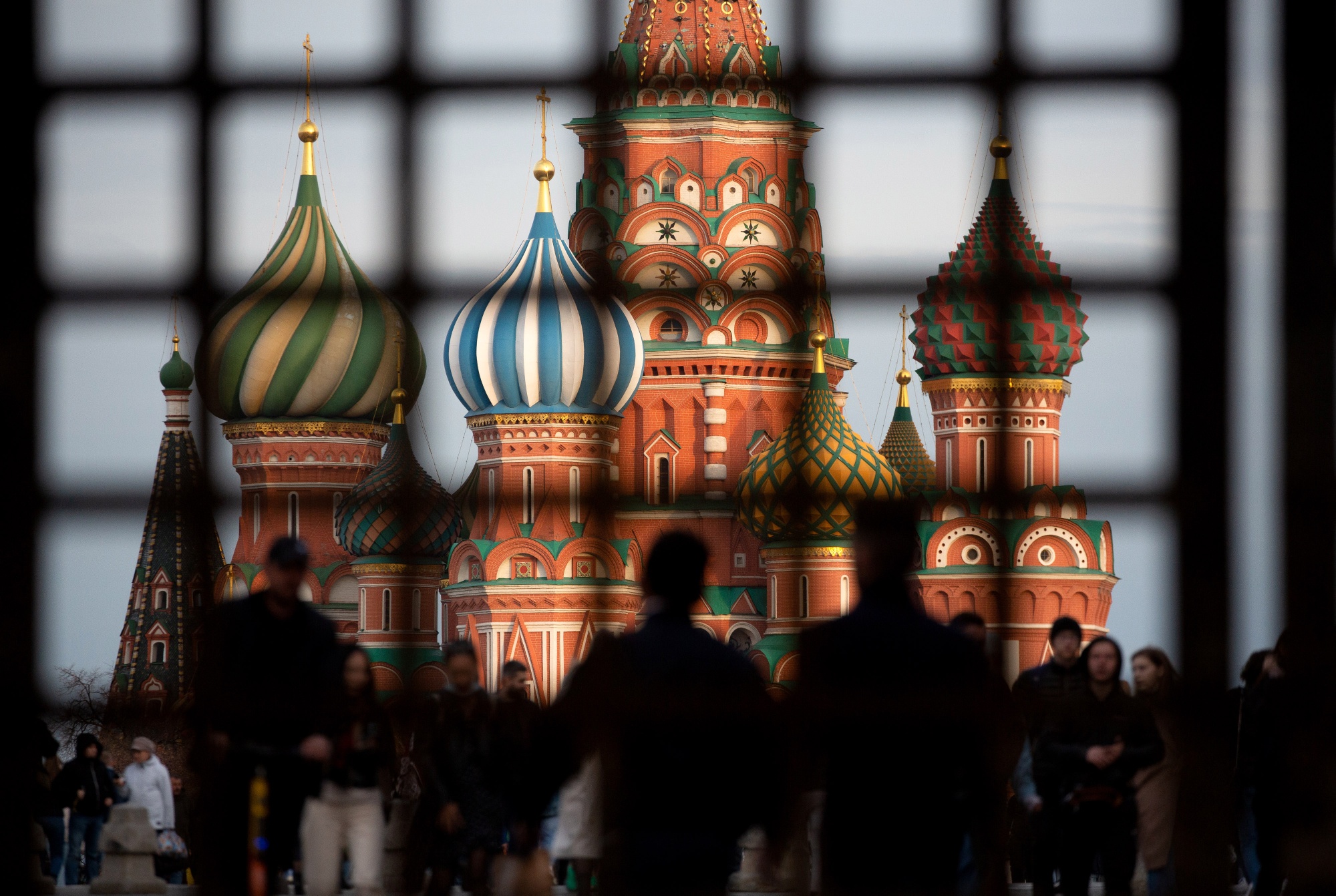 Pedestrians walk by Saint Basil's Cathedral on Red Square in Moscow, Russia.