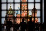Pedestrians walk by Saint Basil's Cathedral on Red Square in Moscow, Russia.