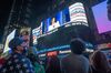 People watch as U.S. Vice President-elect Kamala Harris is displayed on a screen in New York, U.S.