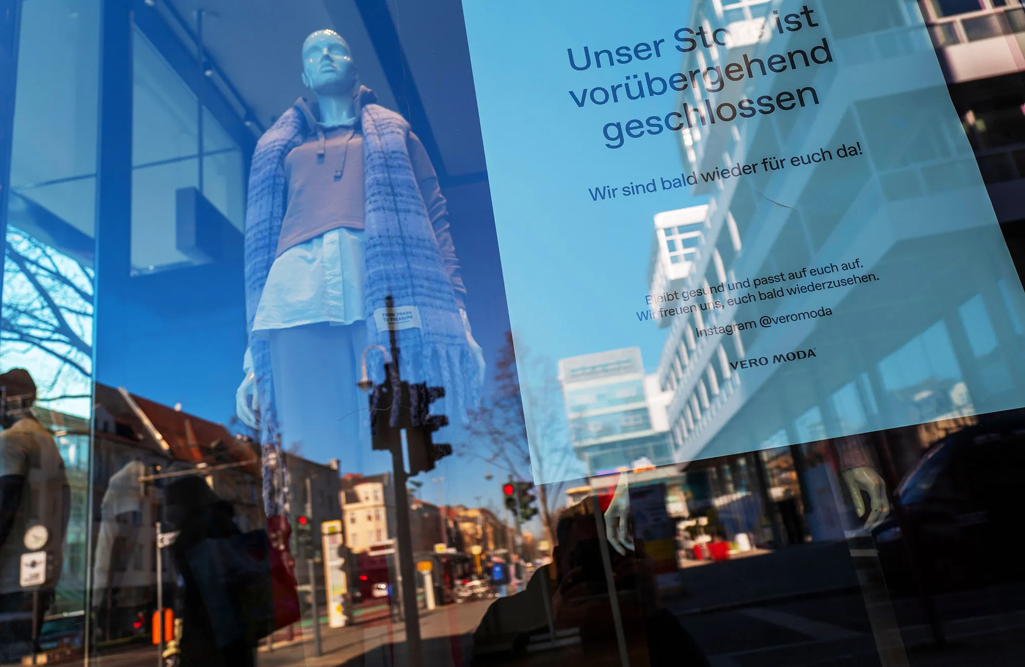 A sign in a fashion retail store reads: "Closed until further notice" in Berlin.