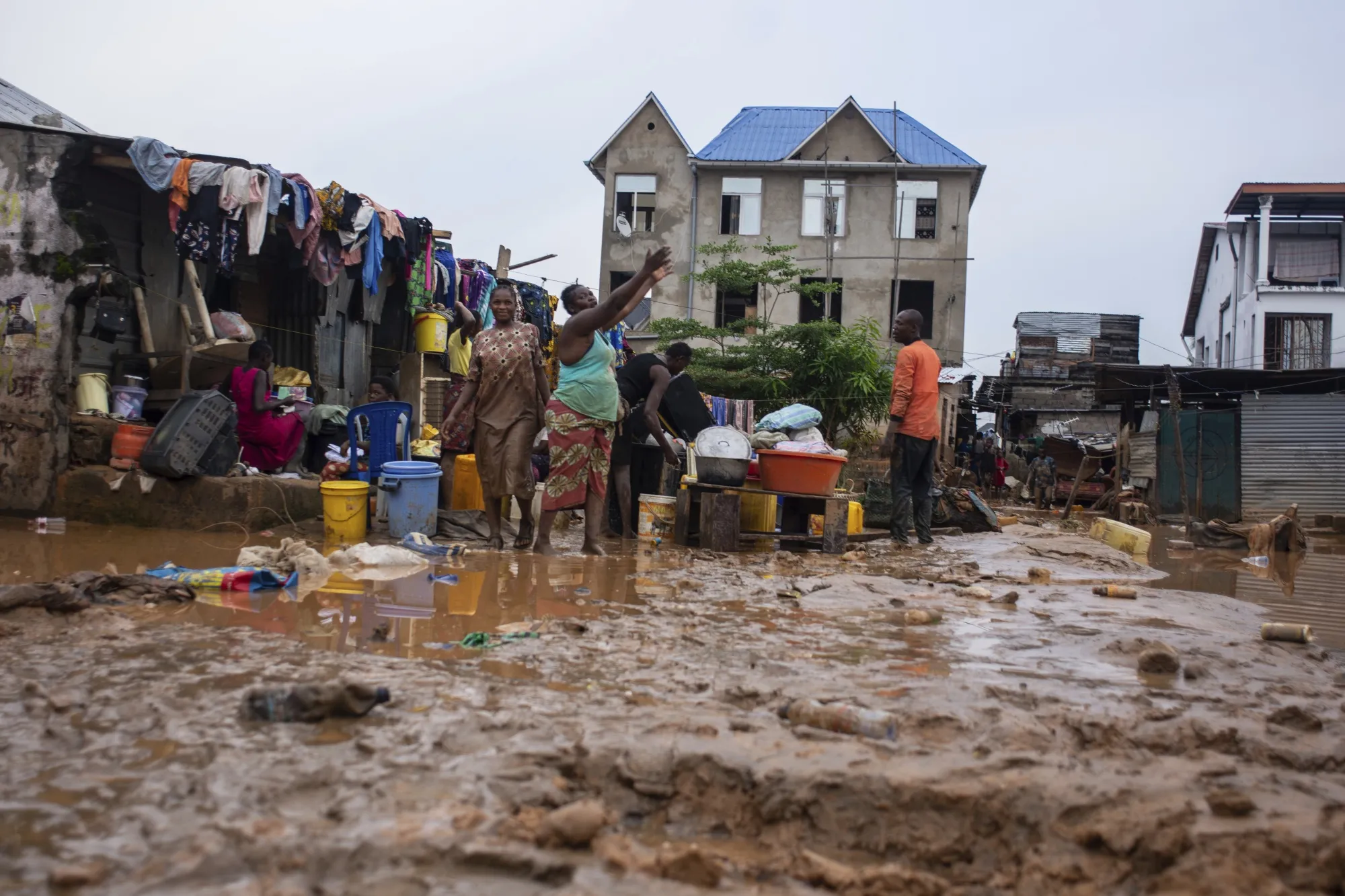 Residents clean up following rains in Kinshasa, Democratic Republic of Congo on December 13.&nbsp;
