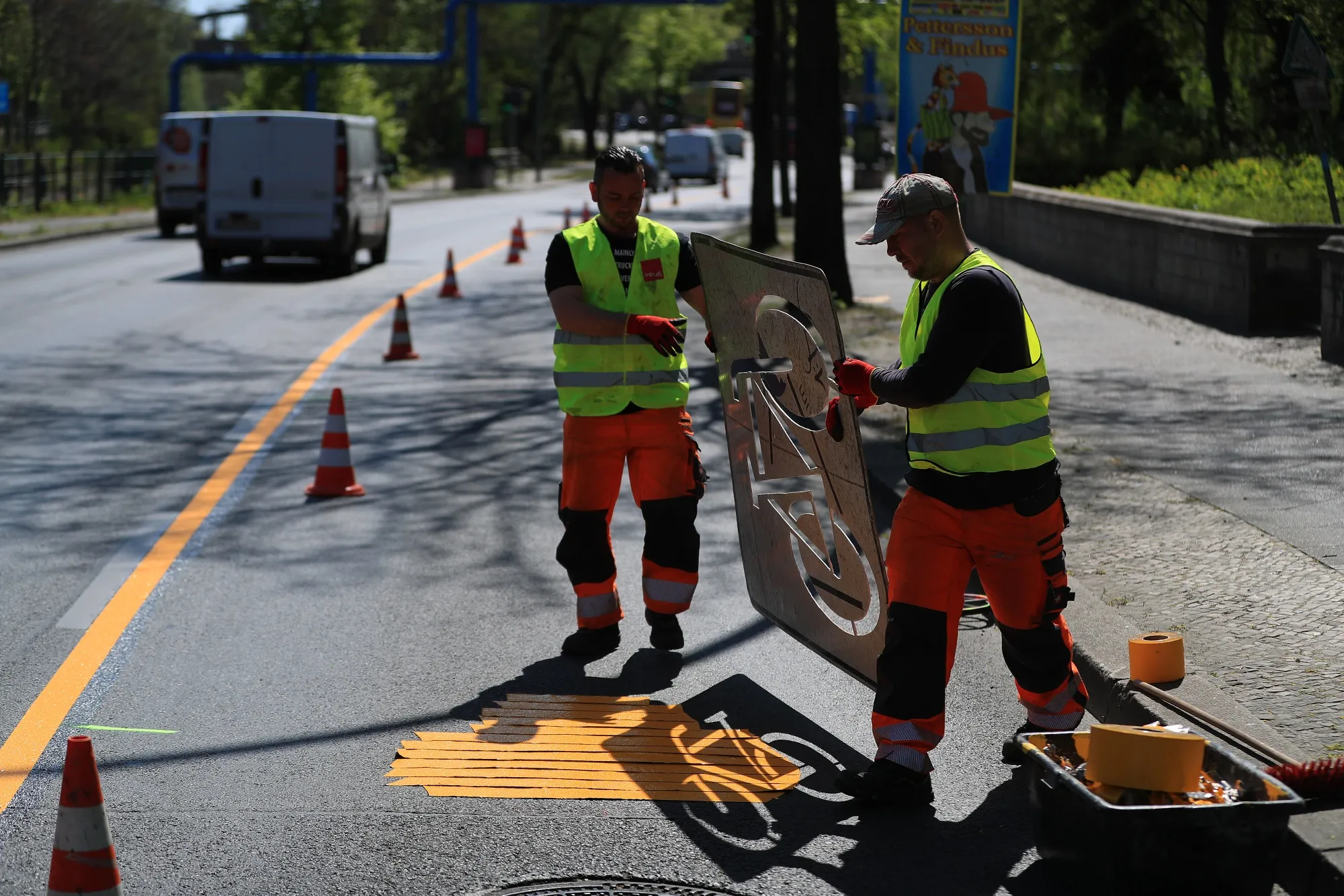 Workers install a pop-up bicycle lane in Berlin on April 23.