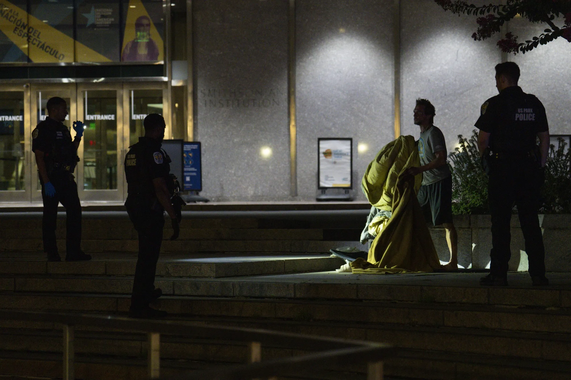 
US&nbsp;Park Police remove a homeless individual from the steps of the Smithsonian National Museum of American History on August 14, 2025 in Washington, DC.

