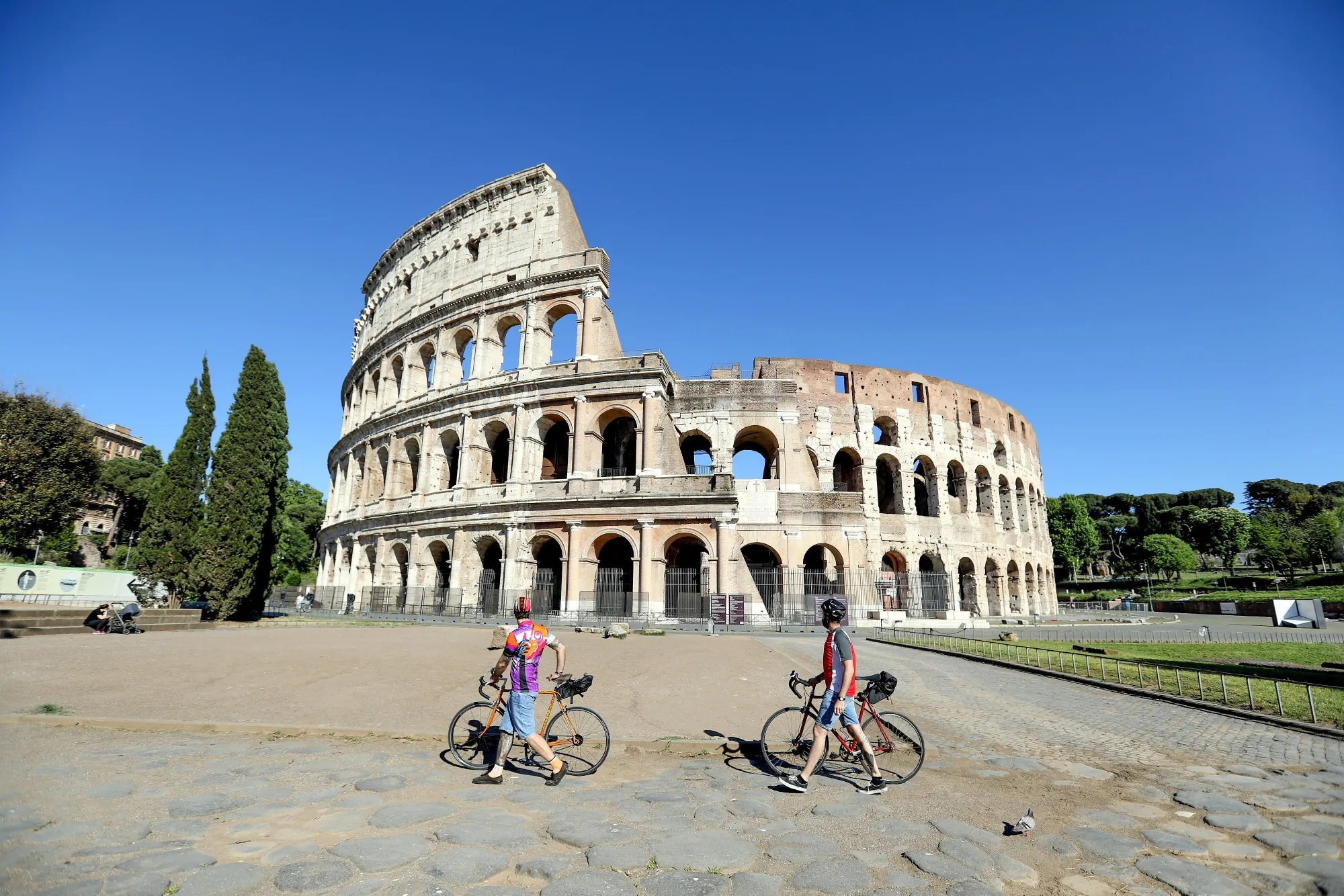 Cyclists stop near the Colosseum in Rome on May 4.