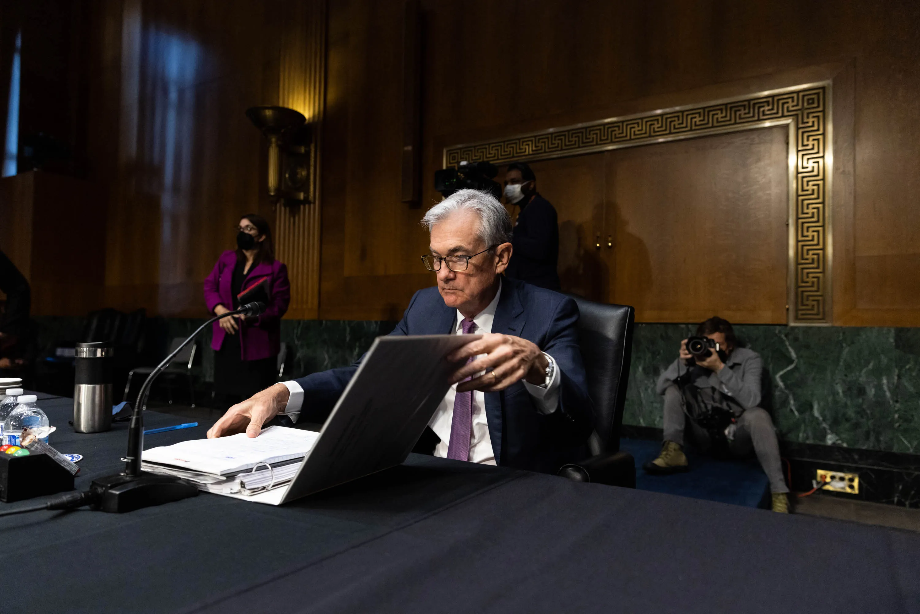 Jerome Powell, chairman of the U.S. Federal Reserve, prepares to depart from a Senate Banking, Housing, and Urban Affairs Committee confirmation hearing in Washington, D.C., U.S., on Tuesday, Jan. 11, 2022. Powell said the central bank will prevent higher inflation from becoming entrenched while cautioning that the post-pandemic economy might look different than the previous expansion.