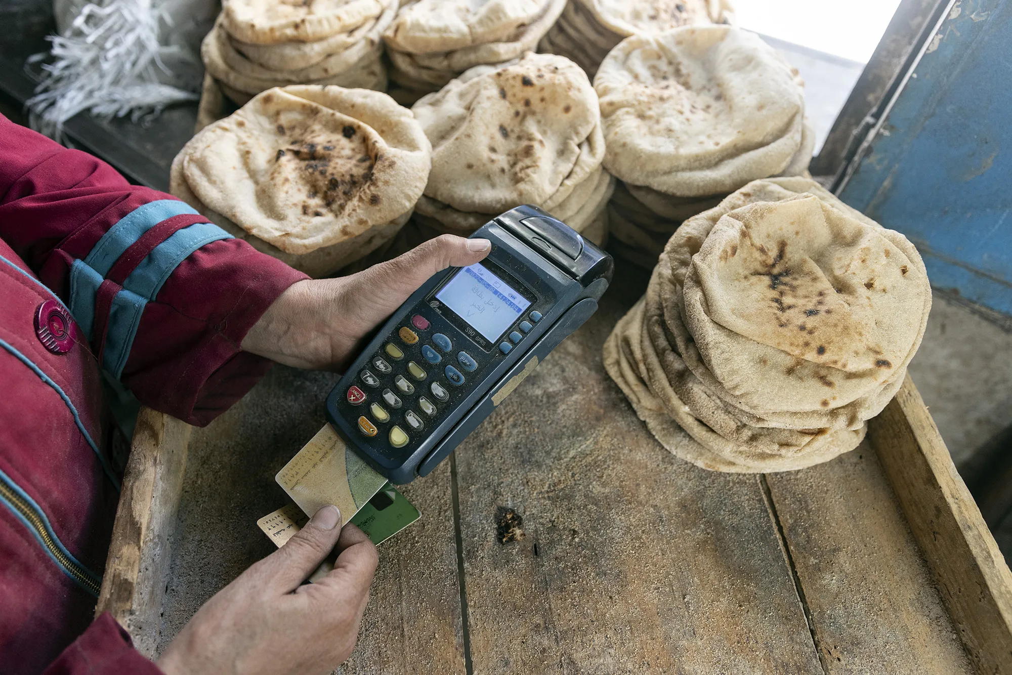 A customer uses a bank card to pay&nbsp;for bread in&nbsp;Cairo, Egypt.&nbsp;