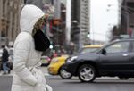 A pedestrian walks on Michigan avenue during the cold weather day in Chicago.