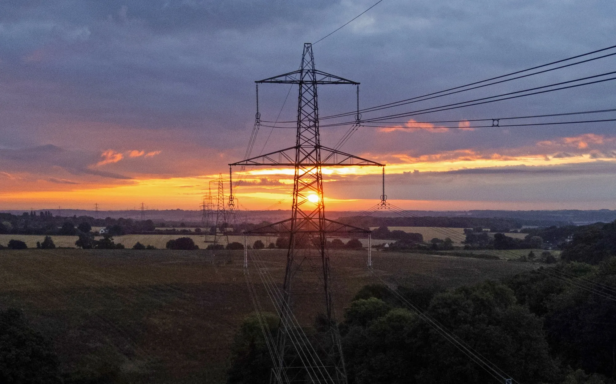 Transmission towers&nbsp;at sunrise near Stevenage, UK. The International Energy Agency foresees the “Age of Electricity” replacing the “Age of Oil.”&nbsp;