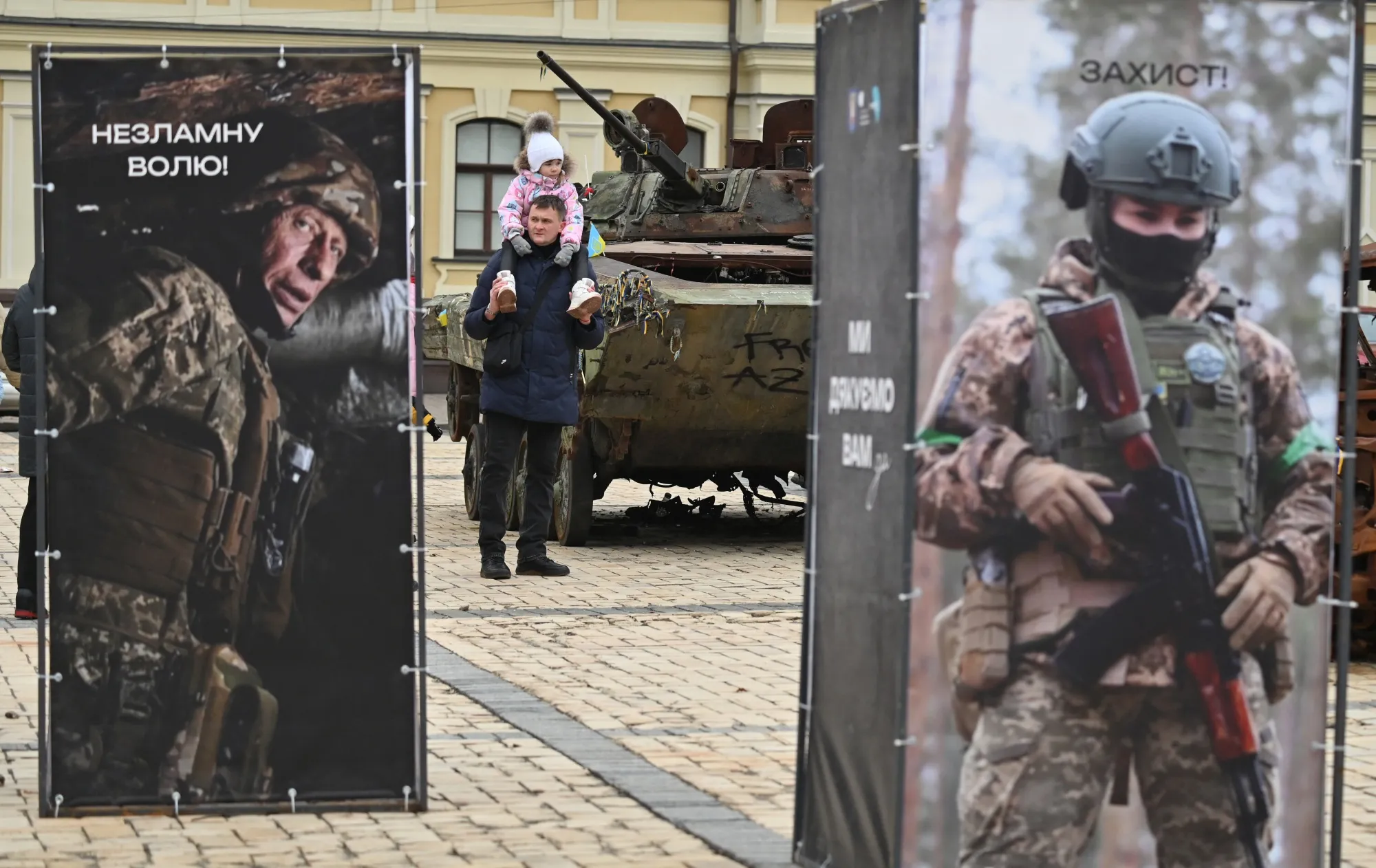 A man passes destroyed Russian military equipment displayed&nbsp;in Kyiv, on Dec. 28.