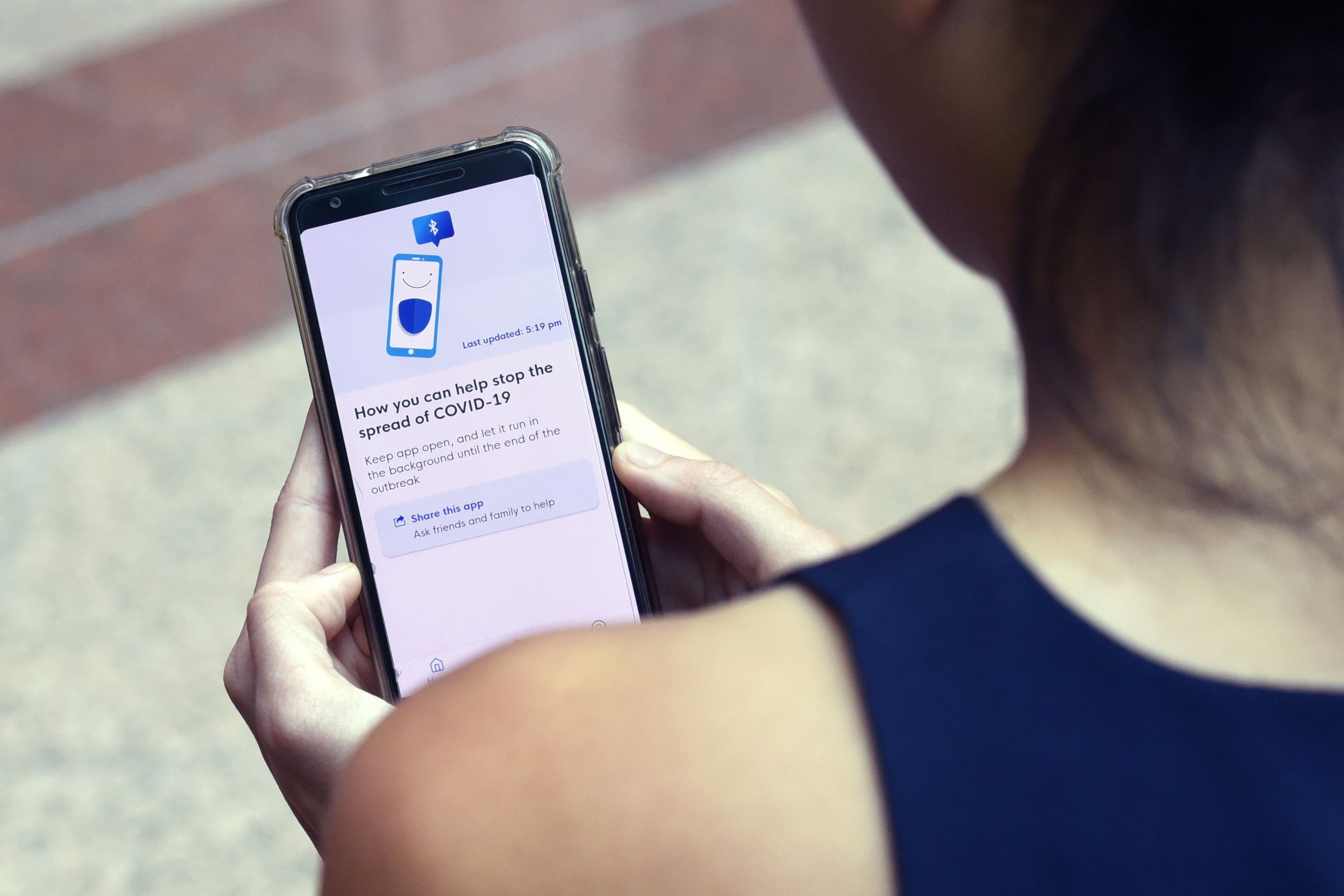 A Government Technology Agency (GovTech) staff demonstrates Singapore's new contact-tracing smarthphone app called TraceTogether in Singapore.