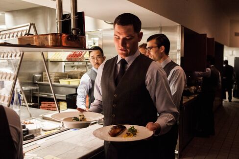 Travis Pranke, who runs food to tables, during lunch service at The Mordern restaurant in New York.