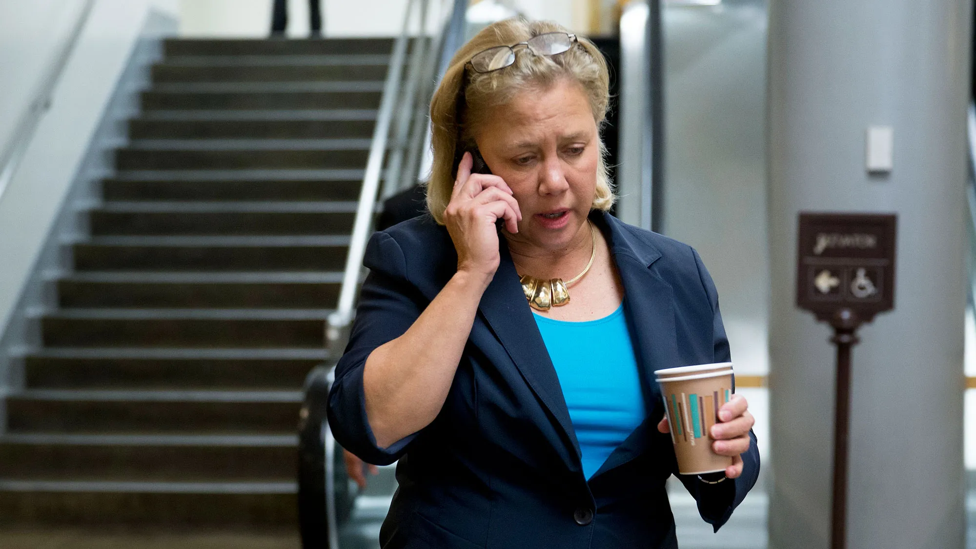 Senator Mary Landrieu, a Democrat from Louisiana, talks on the phone while walking away from the U.S. Capitol Building in Washington, D.C., U.S., on Thursday, Sept. 19, 2014
