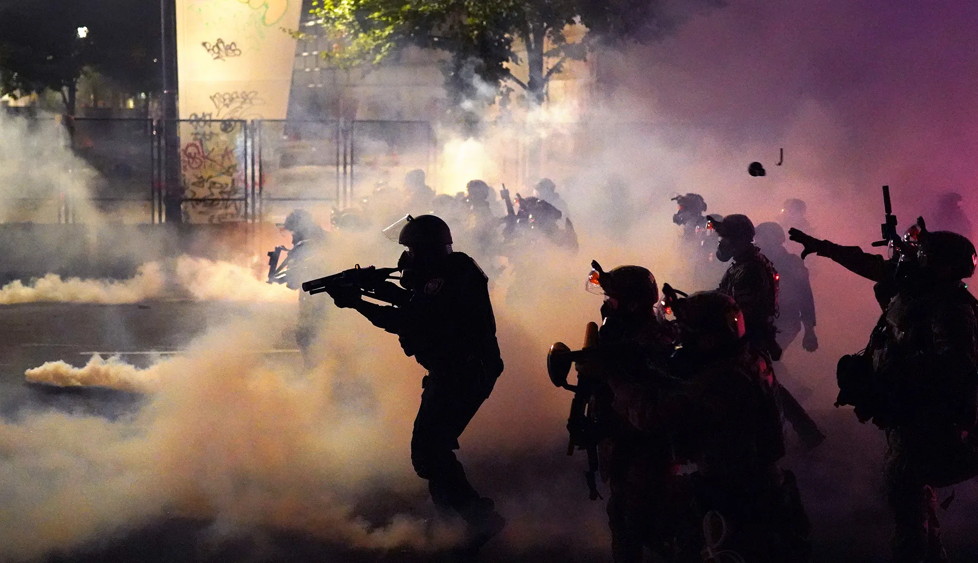 Federal officers deploy tear gas and munitions while dispersing a crowd in Portland on July 24.