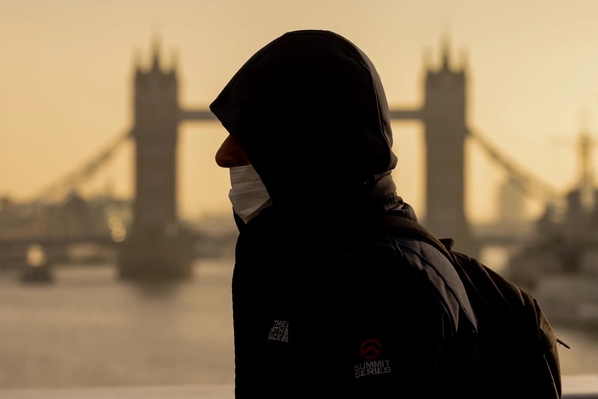 A commuter passes in view of Tower Bridge in London on Nov. 29.