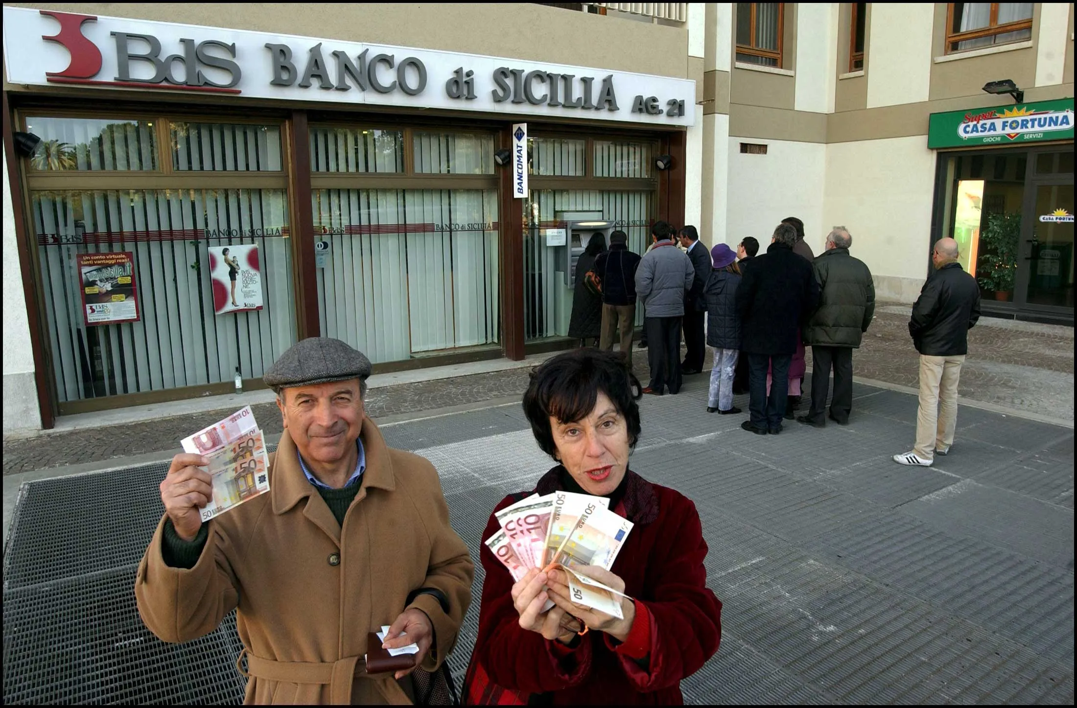 Residents of&nbsp;Palermo, Italy, show off freshly minted euros in the early aughts.