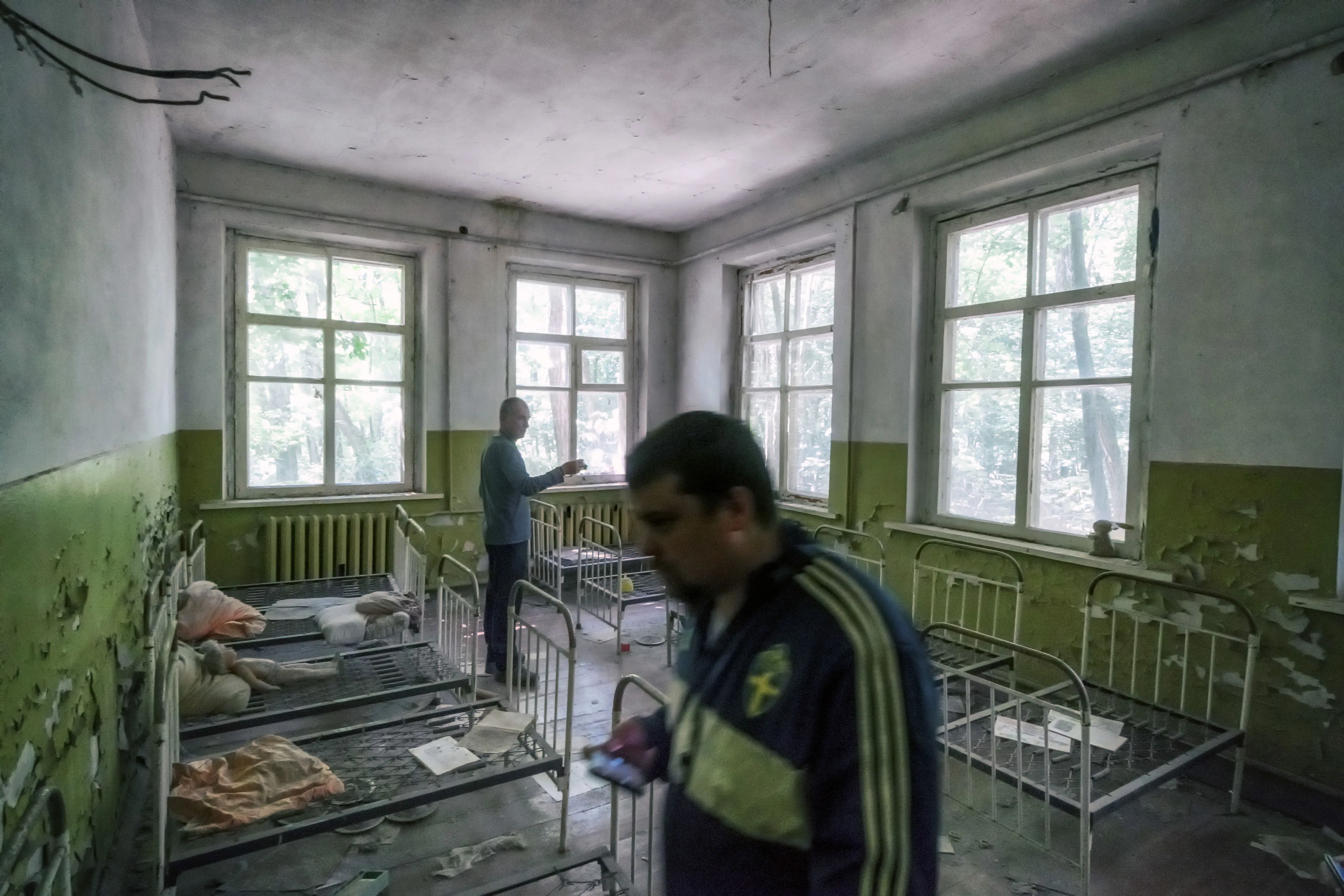 Tourists walk around&nbsp; a former preschool building near Chernobyl.