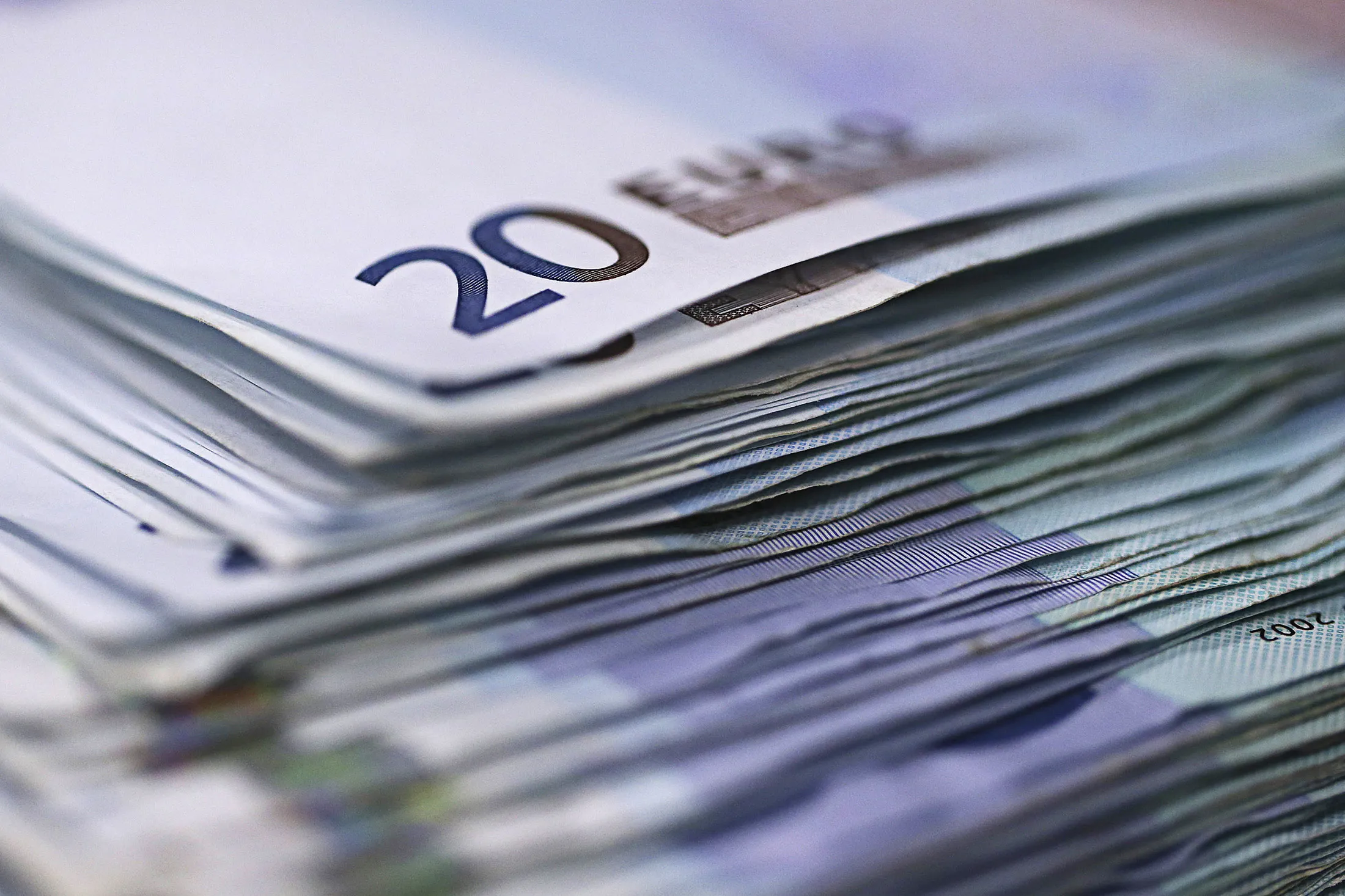 A stack of twenty euro banknotes are arranged for a photograph inside a Travelex store, operated by Travelex Holdings Ltd., in London, U.K., on Monday, Jan. 12, 2015. The euro approached a nine-year low against the dollar as European Central Bank officials fueled speculation the institution will start a program of government-bond buying as early as next week to stave off deflation.
