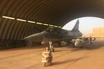 A soldier of the France's Barkhane mission stands next to a Mirage 2000 on November 6, 2017 in a French military base in Niamey. 