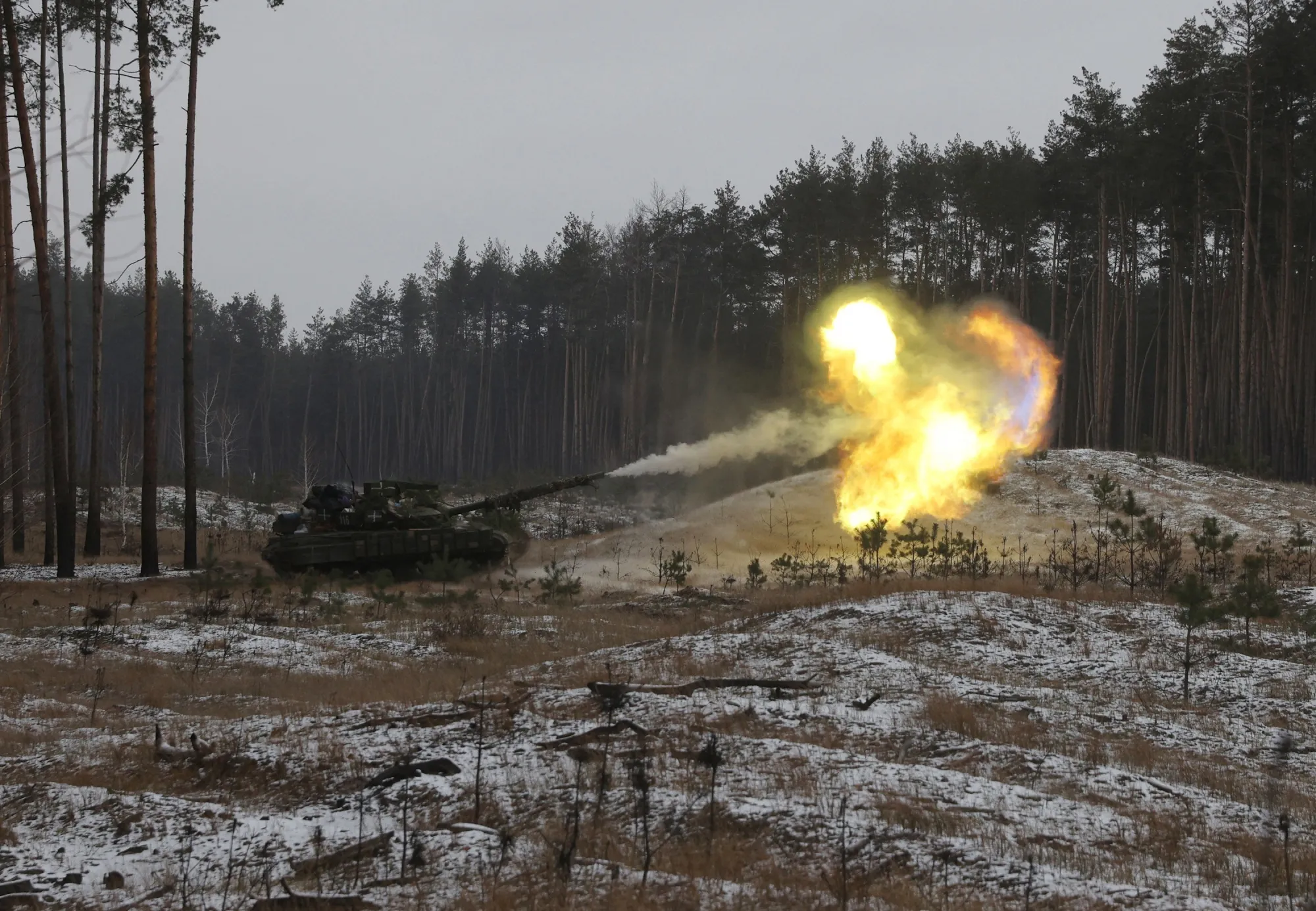 A Ukrainian tank fires at Russian positions near Kreminna, Lugansk region, Ukraine, on Jan. 12.