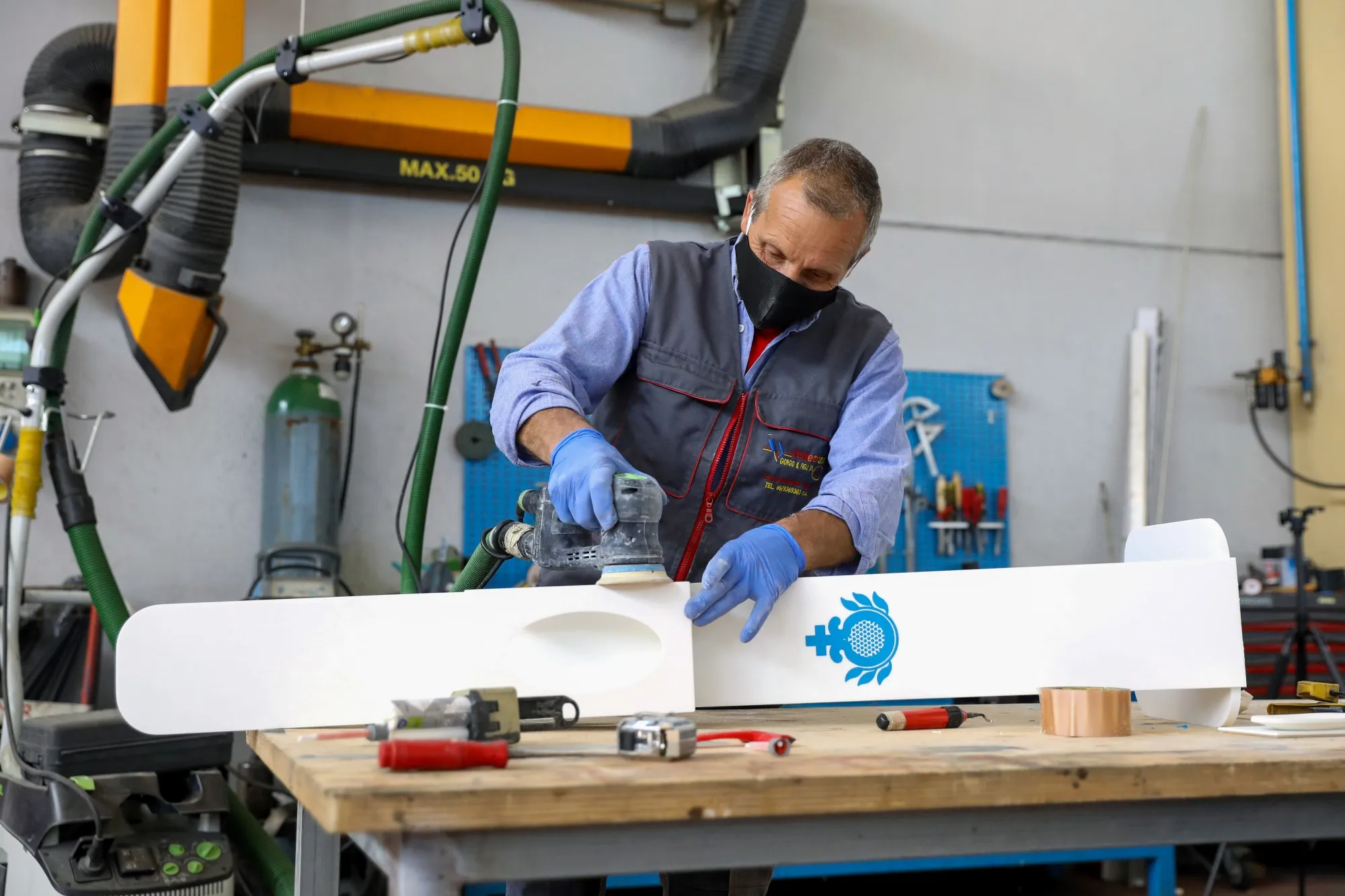 A worker finishes a hand sanitizing station for a hospital as work resumes at a factory near Rome, on May 4.