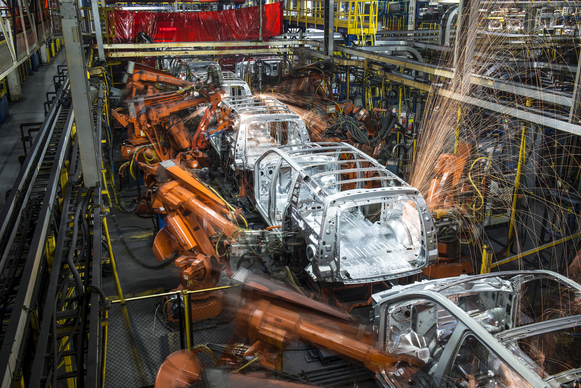 Robotic machines weld together the frames of vehicles at the General Motors assembly plant in Arlington, Texas.