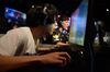 Attendees play Activision Blizzard Inc.'s Overwatch computer game at the AOC Open e-Sports event in Tokyo.