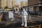 A worker in protective gear at a neighborhood placed under lockdown in Beijing on Nov. 10.