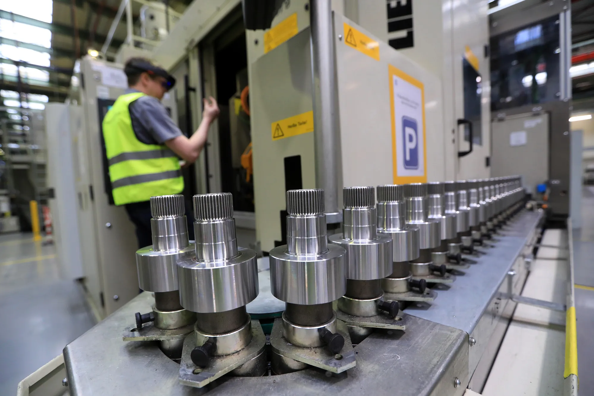 A worker checks&nbsp;gear wheels for vehicles at a&nbsp;ZF factory.