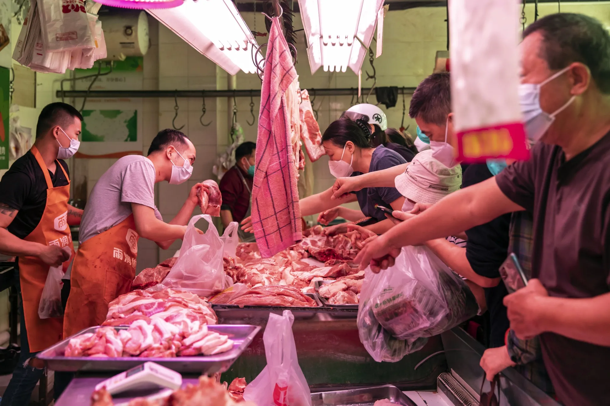 Customers purchase pork at a food market in Shanghai in June.&nbsp;