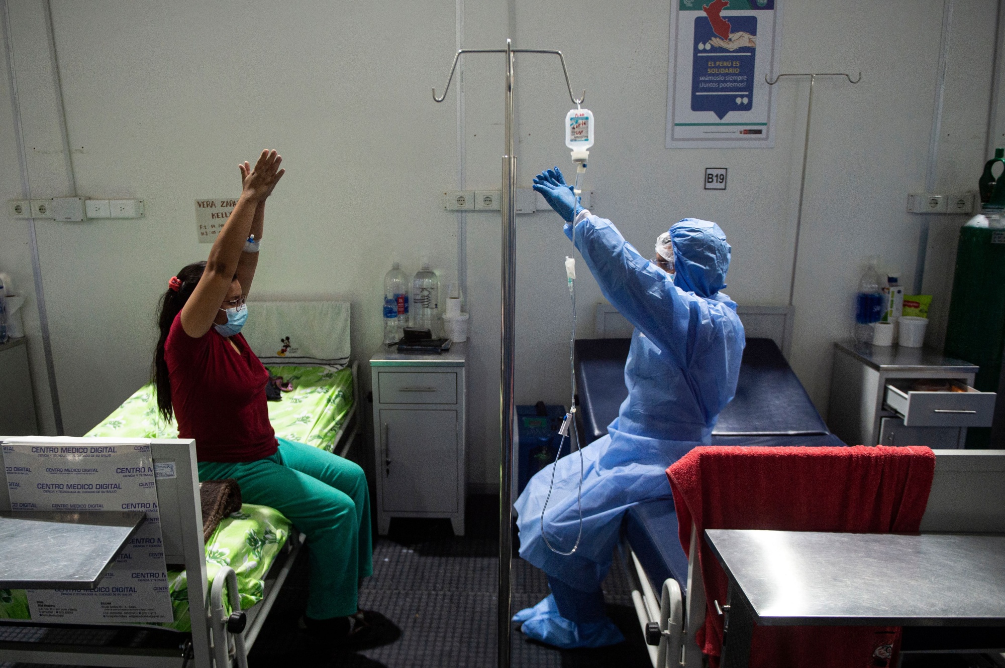 A health professional helps a Covid-19 patient exercise at the Intensive Care Unit of the Virgen de Fatima contingency hospital, in Peru.