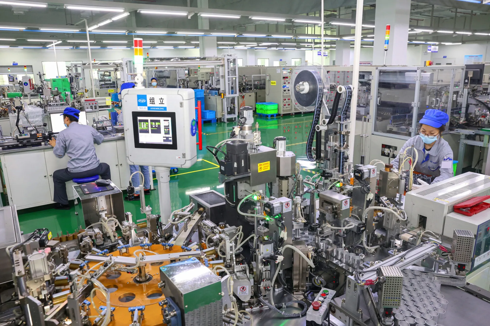 Employees produce electronic components at a factory in Nantong.