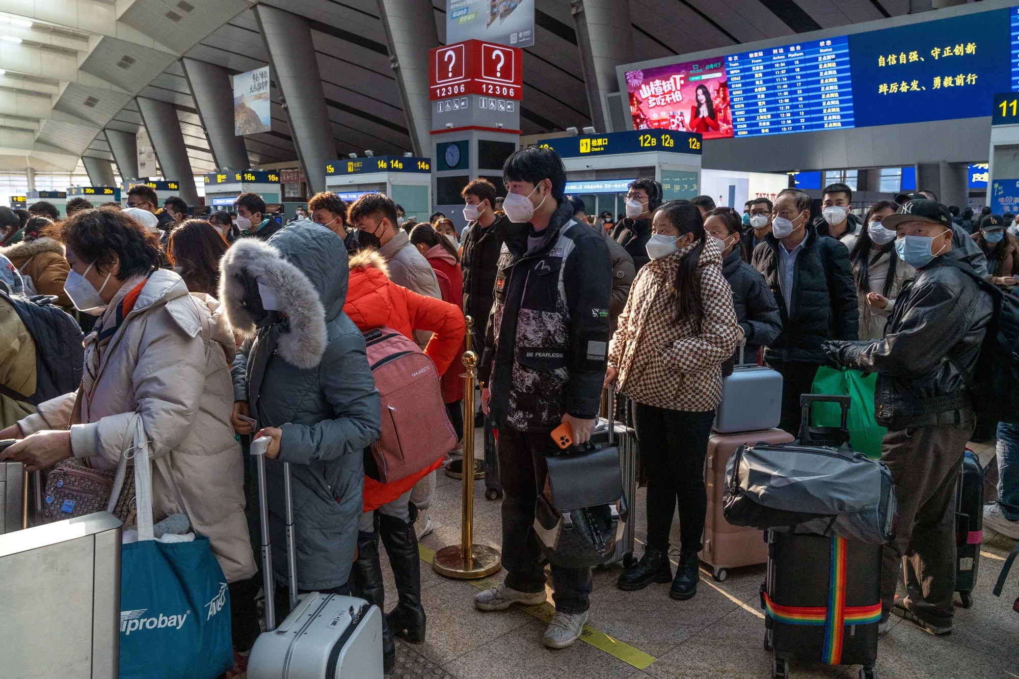 Travelers at a train station in Beijing on&nbsp;Dec. 21. How well China manages its reopening after the sudden elimination of restrictions, and the massive wave of infections that has resulted, will be a key economic theme of 2023.