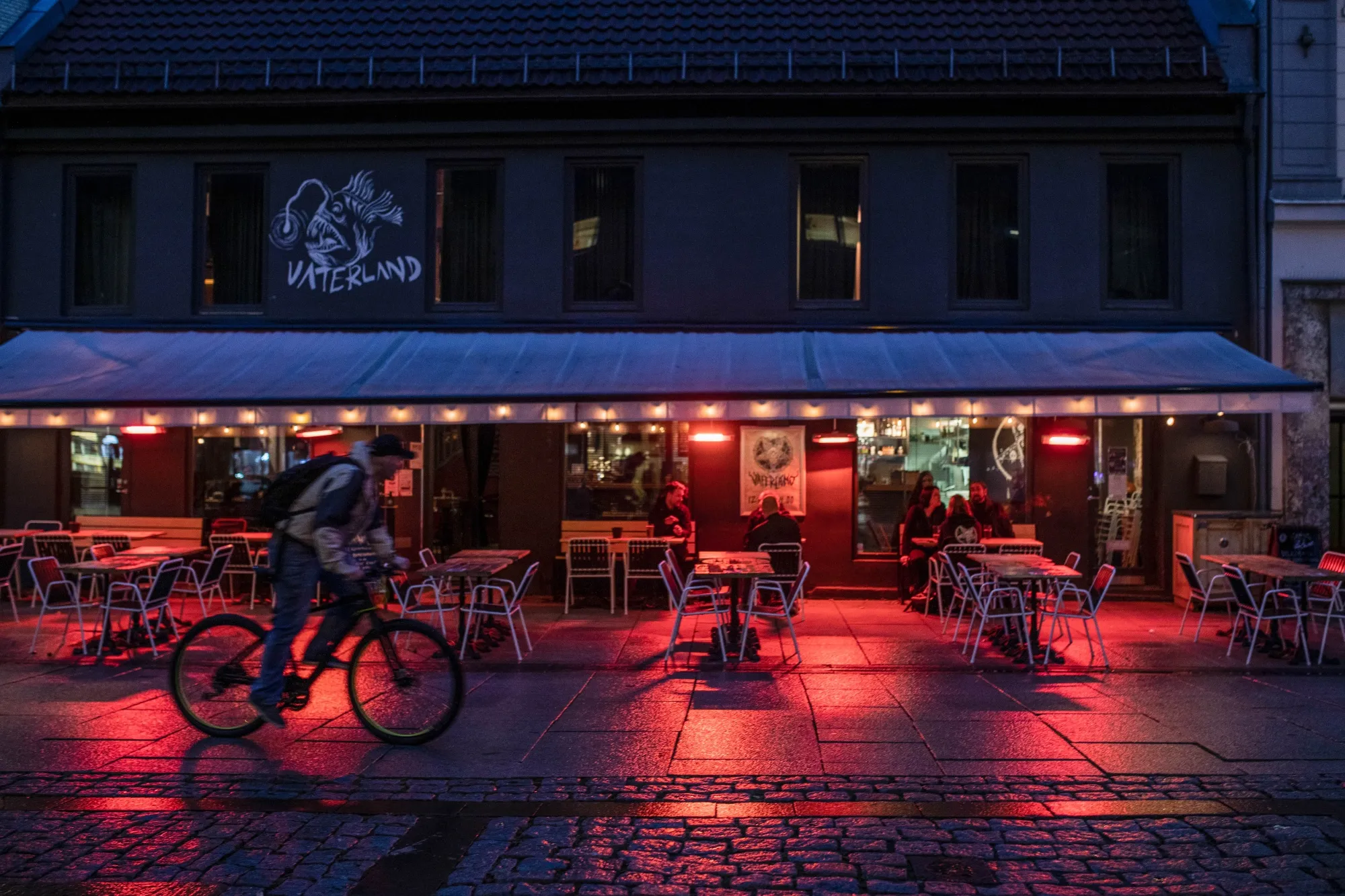 A cyclist passes a bar in the Gronland neighborhood in Oslo, on Sept. 23.