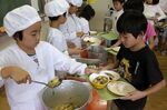 Students serve each other lunch at a Tokyo elementary school. 