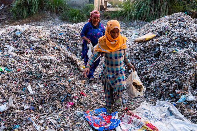Workers leave after a days work at a plastic scrap contractors yard, in Muzaffarnagar District, Uttar Pradesh, India, on Thursday, Nov. 17, 2022. Photographer: Prashanth Vishwanathan/Bloomberg