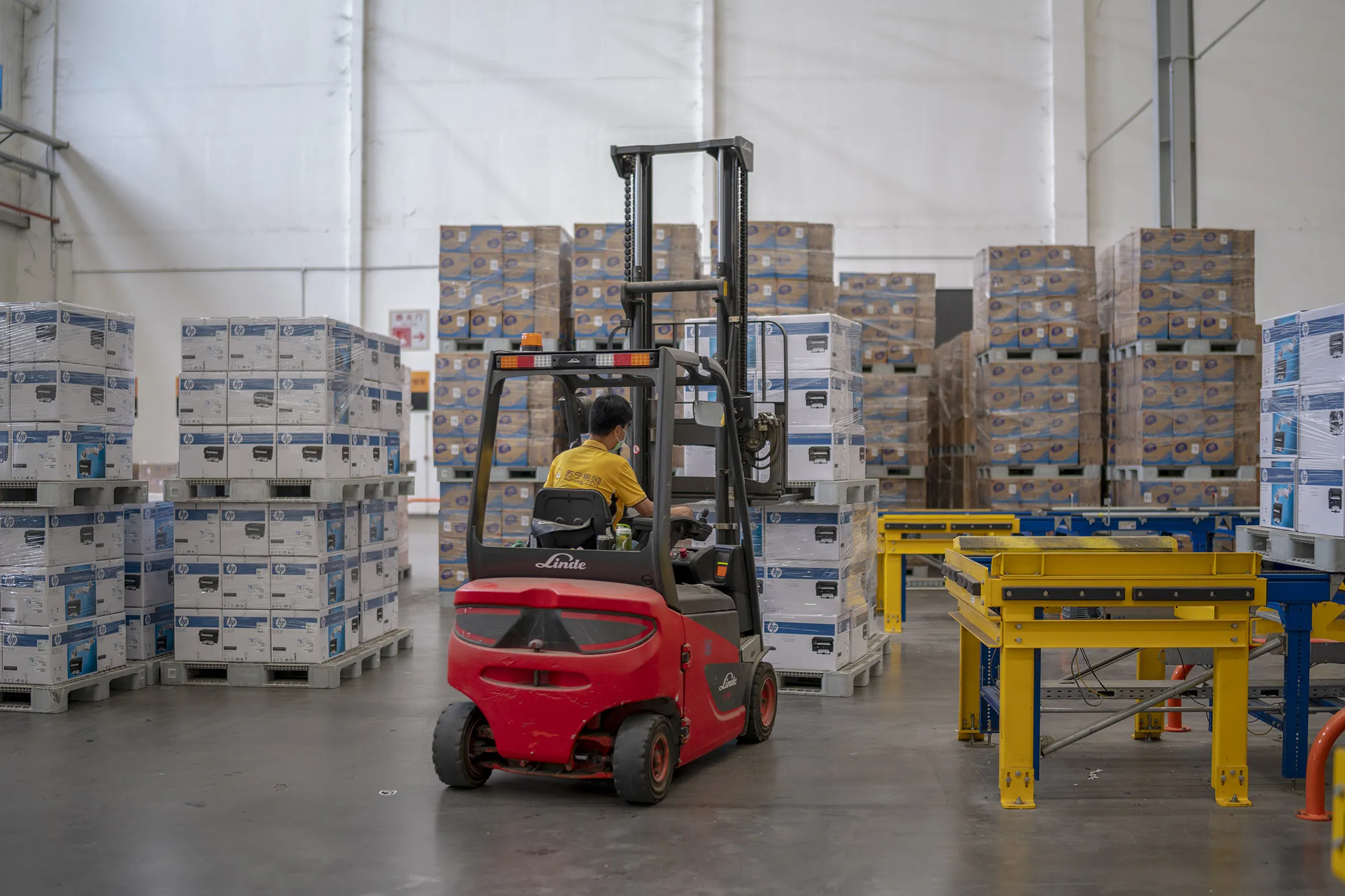 A worker arranges express parcels at a logistic base of Suning.com Co., in Nanjing, China in 2020.