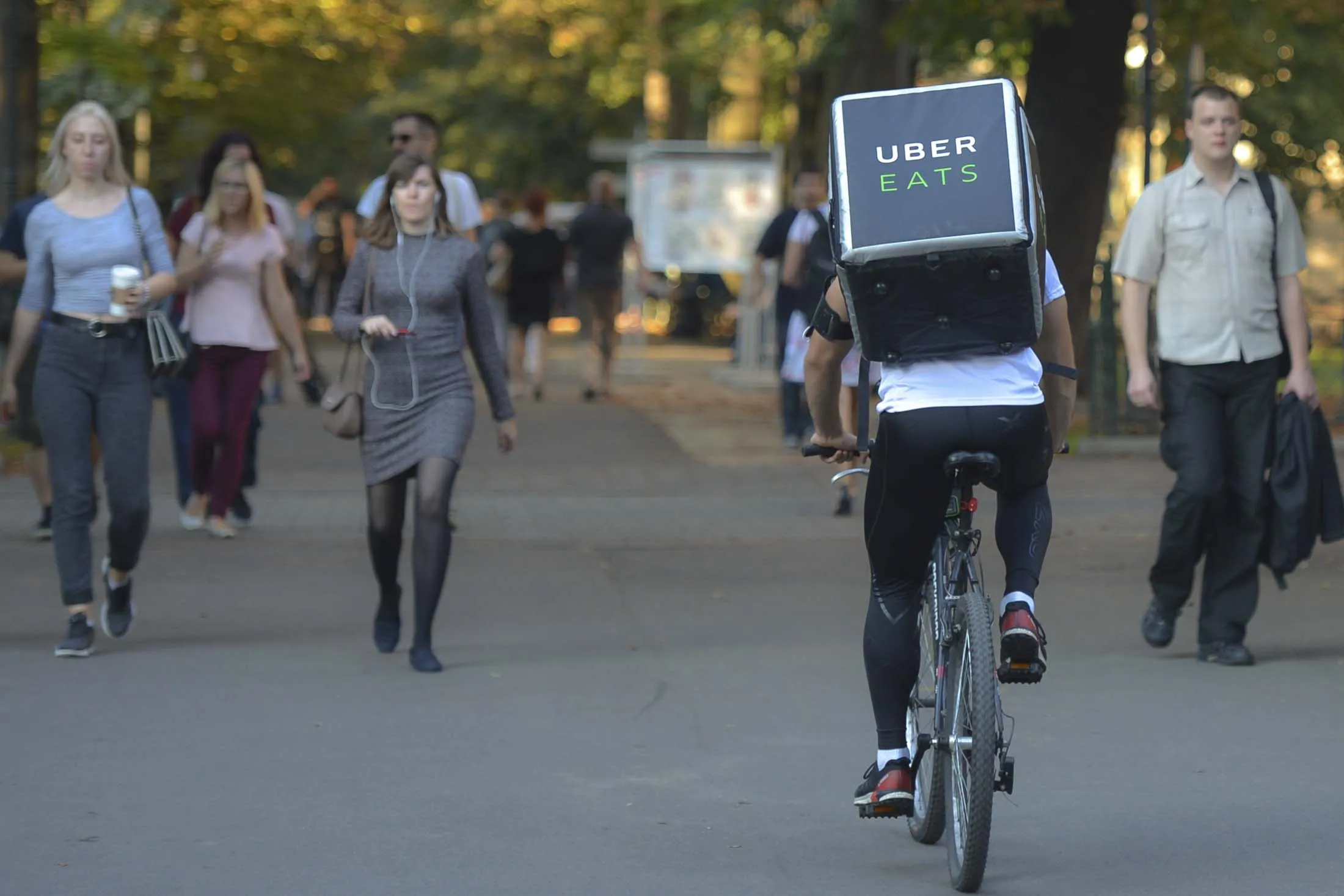 A Uber Eats courier seen in Krakow's Planty park. On Wednesday, September 19, 2018, in Krakow, Poland. (Photo by Artur Widak/NurPhoto via Getty Images)